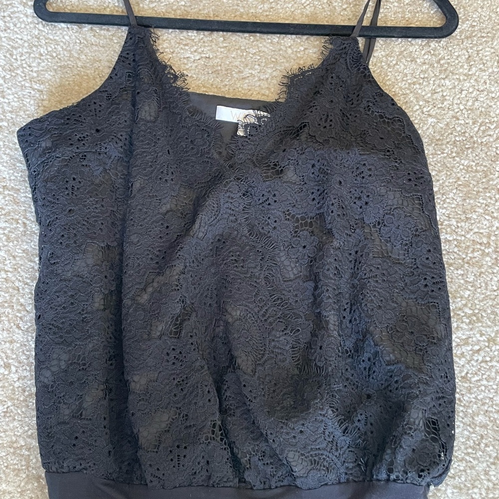 Lace bodysuit. Spaghetti strap V neck with snap by chest. Adjustable straps.